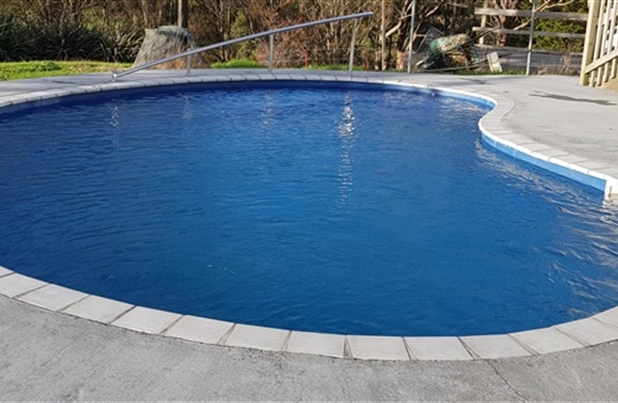 kidney shaped pool after repairs and reline